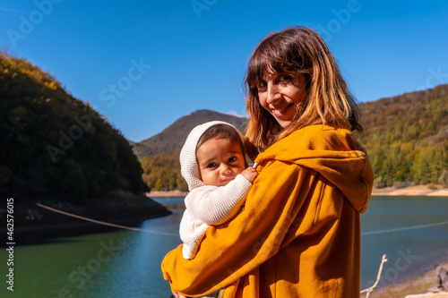 Irati forest or jungle in autumn, a mother with her baby in the Irabia reservoir. Ochagavia, northern Navarra in Spain photo