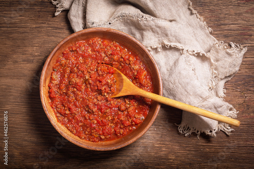 bowl of meat sauce bolognese on a wooden background photo