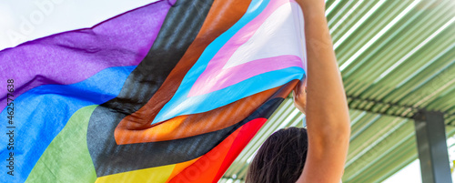 Progress pride flag. Lesbian Girl Holding LGBT Flag. photo