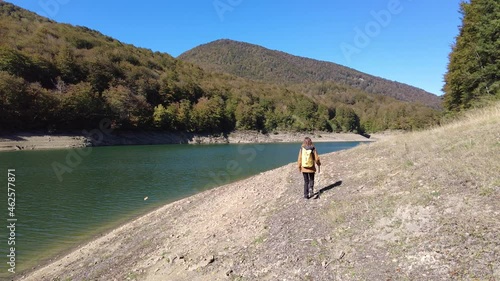 Irati forest or jungle in autumn, a young woman walking through the beautiful Irabia reservoir. Ochagavía, north of Navarra in Spain, 4k video photo