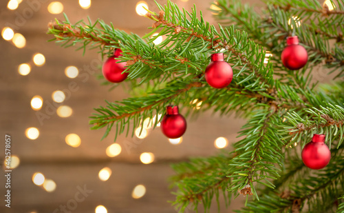 Christmas background with christmas tree, ornaments and defocused lights	
