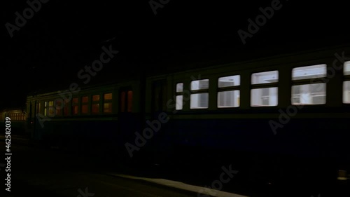 Night railroad station: Passenger train arrives photo