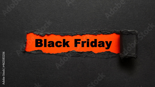 Black torn paper with Black friday text. Sale concept.