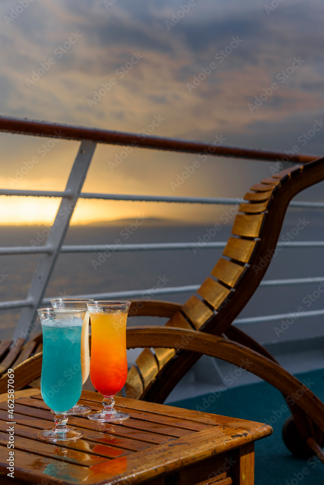 Sun loungers to enjoy the ocean views, with a cocktail table next to it on the ship's deck. Sun loungers to enjoy the ocean views, with a cocktail table next to it on the ship's deck.