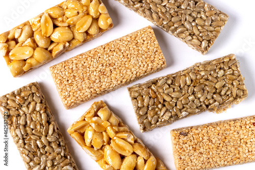 Rectangular pieces of kozinak - sunflower, peanut and sesame seeds. Isolated on white background. Close-up. Top view.