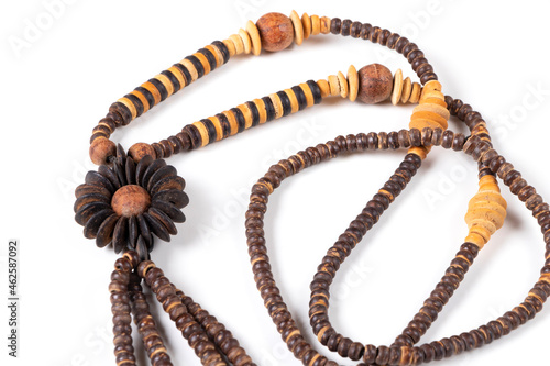 Handmade wooden souvenir beads, Thailand. Isolated on white background. Top view. Close up.