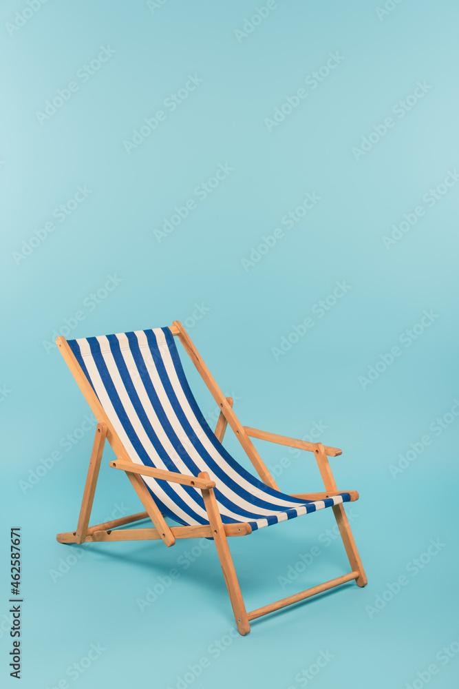 striped deck chair on blue background