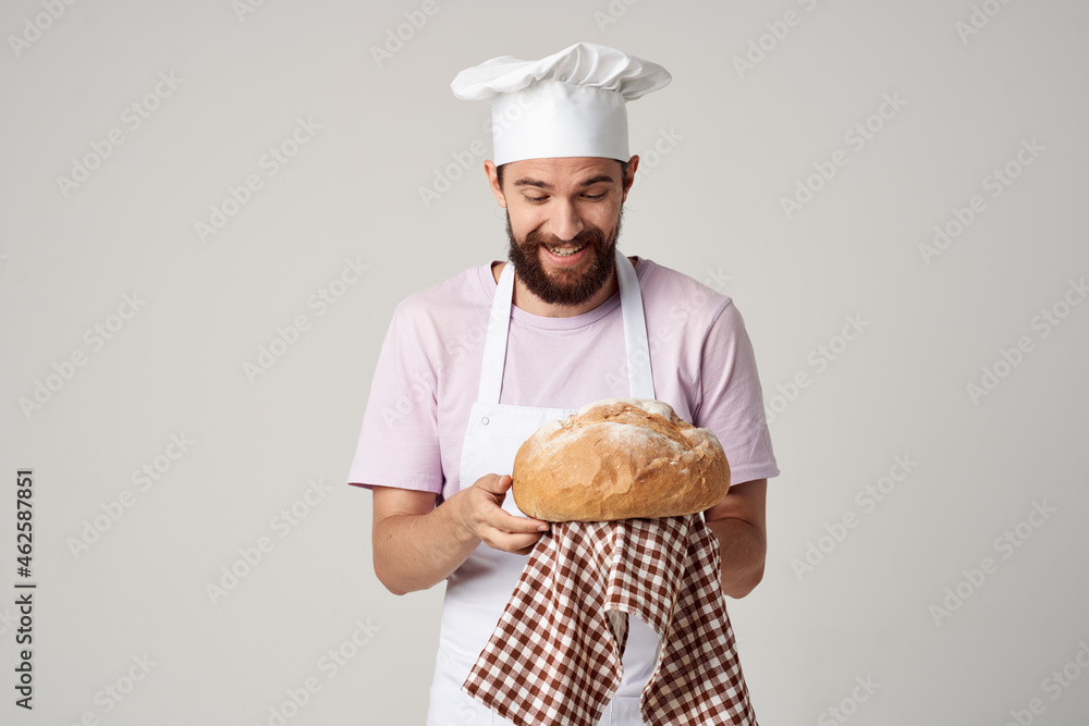 a man in a chef's uniform holding bread in his hands kitchen Professional industry a man in a chef's uniform holding bread in his hands kitchen Professional industry