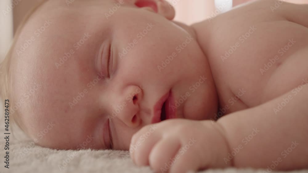 Healthy infant sleeping at home. Beautiful small baby sleeping. Close-up of infant sleeping. Macro shot of a small caucasian baby resting. Shot of napping child, afternoon nap.. Healthy infant sleeping at home. Beautiful small baby sleeping. Close-up of infant sleeping. Macro shot of a small caucasian baby resting. Shot of napping child, afternoon nap..