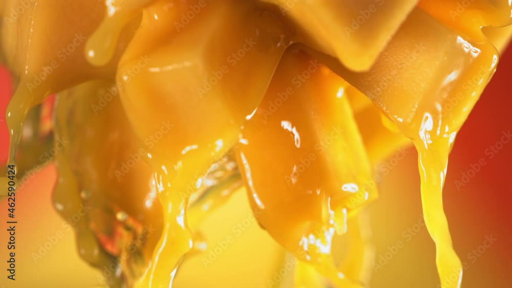 Flowing Mango Juice from half slide Mango , macro shot in slow motion Flowing Mango Juice from half slide Mango , macro shot in slow motion