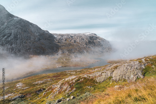 Cloud in the beautiful valley landscape, winding river, rocky mountains and autumn colors