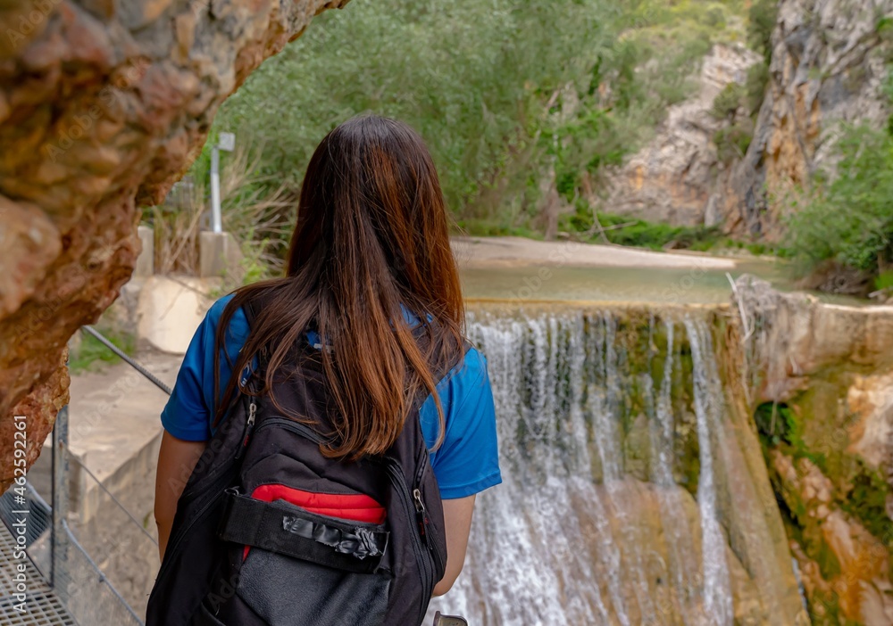 Girl looks at the waterfall from the walkways