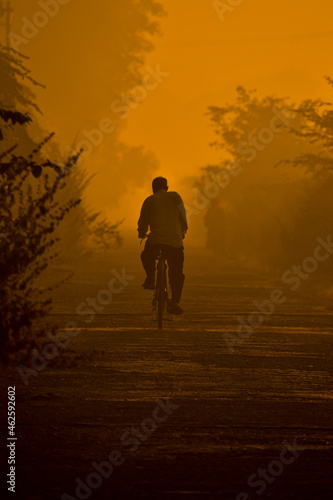 silhouette of a person on a bike