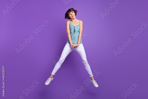 Full length body size view of attractive cheerful girl jumping fooling good mood isolated over bright purple violet color background
