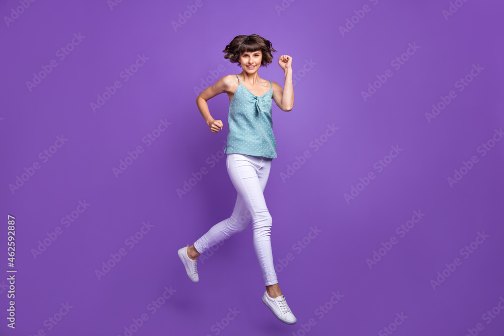 Full length body size view of attractive cheerful girl jumping running isolated over bright violet purple color background