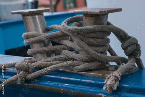 Ship bollard with ropes to which boat is moored