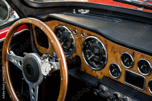 cockpit of classic car with gauges and steering wheel