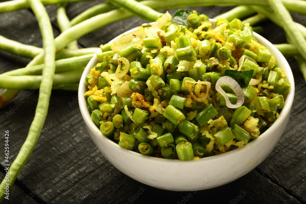 bowl of delicious homemade beans thoran from Kerala cuisine, green bean stir fry with coconut and spices. bowl of delicious homemade beans thoran from Kerala cuisine, green bean stir fry with coconut and spices.