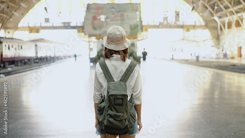 Traveler backpacker Asian woman travel in Bangkok, Thailand. Happy young female direction and looking on location map at train station before travel.