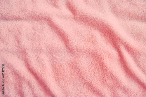 Fluffy gentle pastel pink fabric with waves and folds. Soft pastel textile texture.