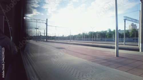 The passenger train drives off from the platform, view from the window of the carriage photo