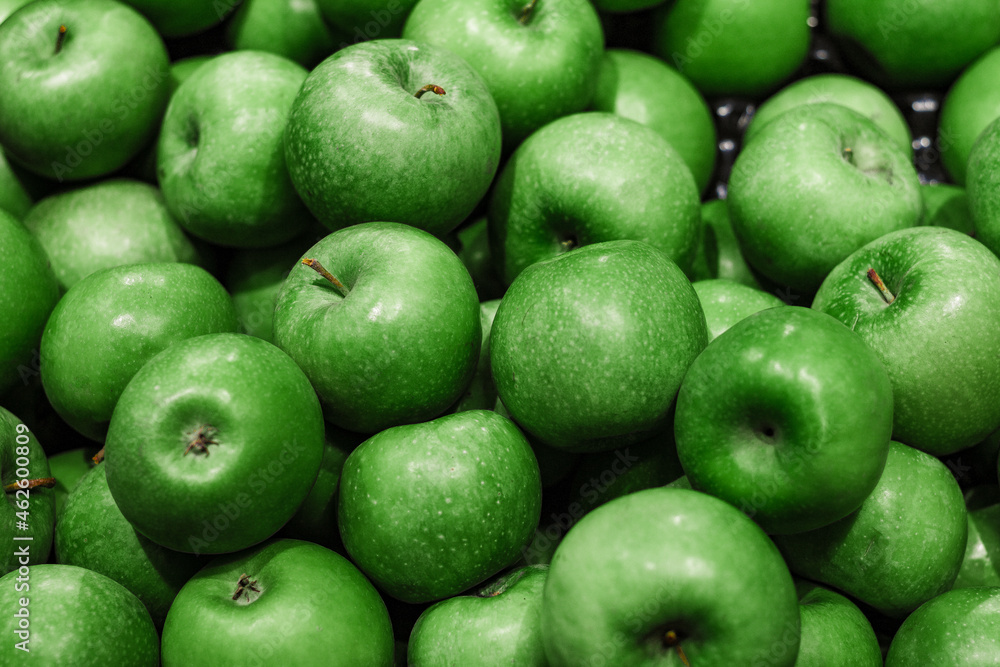 rich green apples are piled on top of each other in a mess rich green apples are piled on top of each other in a mess
