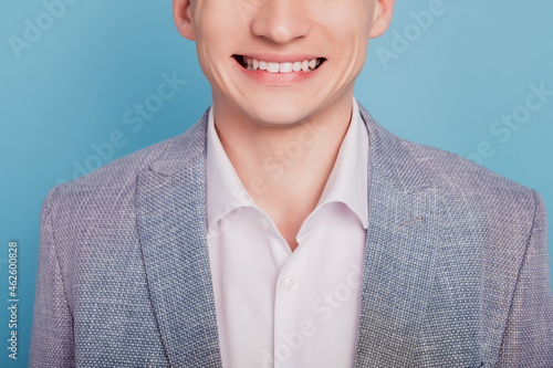 Cropped photo of young man chappy positive smile oral care teeth clinic dentistry isolated over blue color background