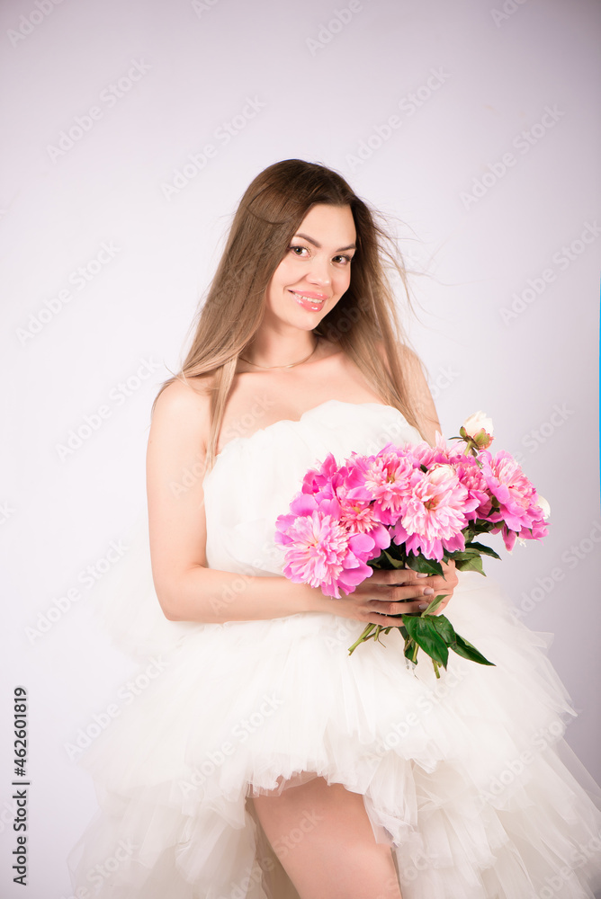 Beautiful smiling woman with a wreath of peonies on the head Beautiful smiling woman with a wreath of peonies on the head
