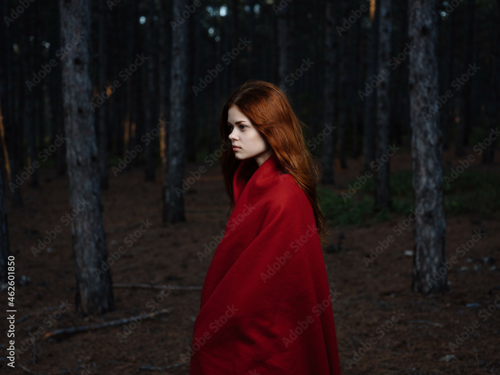 woman in forest with red plaid travel posing