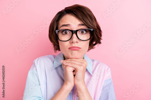 Photo of young woman unhappy sad upset hands touch chin think annoyed isolated over pastel color background