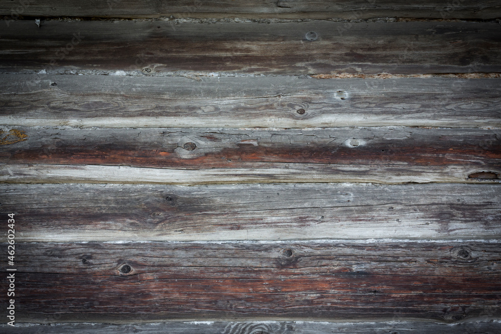 Wooden logs of an old house. Close-up. Weathered natural gray wood texture. Background. Horizontal photo Wooden logs of an old house. Close-up. Weathered natural gray wood texture. Background. Horizontal photo