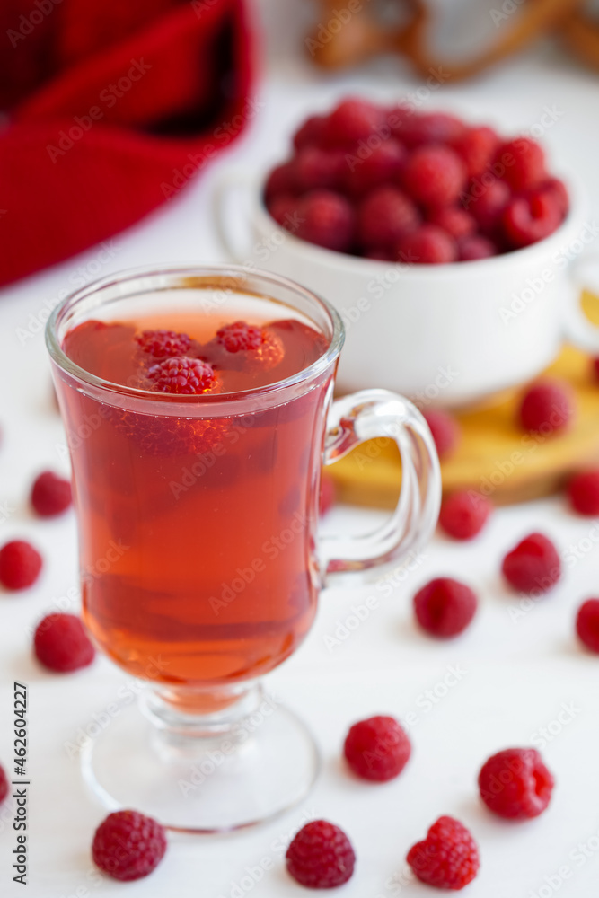 raspberry drink on a gray stone background, walls, glass cup with compote, fresh raspberries on a wooden table, cooling drink raspberry drink on a gray stone background, walls, glass cup with compote, fresh raspberries on a wooden table, cooling drink