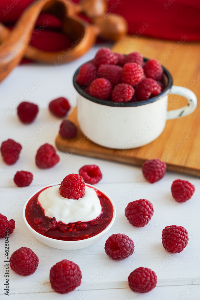 Raspberry jam in glass bowl with spoon isolated on white background Raspberry jam in glass bowl with spoon isolated on white background