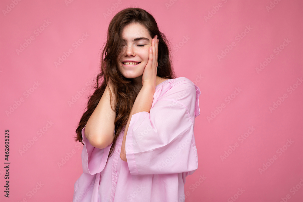 Photo of young positive happy smiling beautiful woman with sincere emotions wearing stylish clothes isolated over background with copy space and covering ears Photo of young positive happy smiling beautiful woman with sincere emotions wearing stylish clothes isolated over background with copy space and covering ears