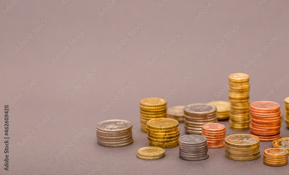 Coins Money US dollars and Euros on a gray background, different monetary coins Coins Money US dollars and Euros on a gray background, different monetary coins