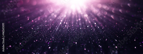 Abstract background of purple-pink  gold glitter lights. De-focused background.