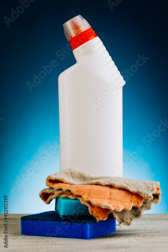 Various bottles of cleaning products on a blue background. photo