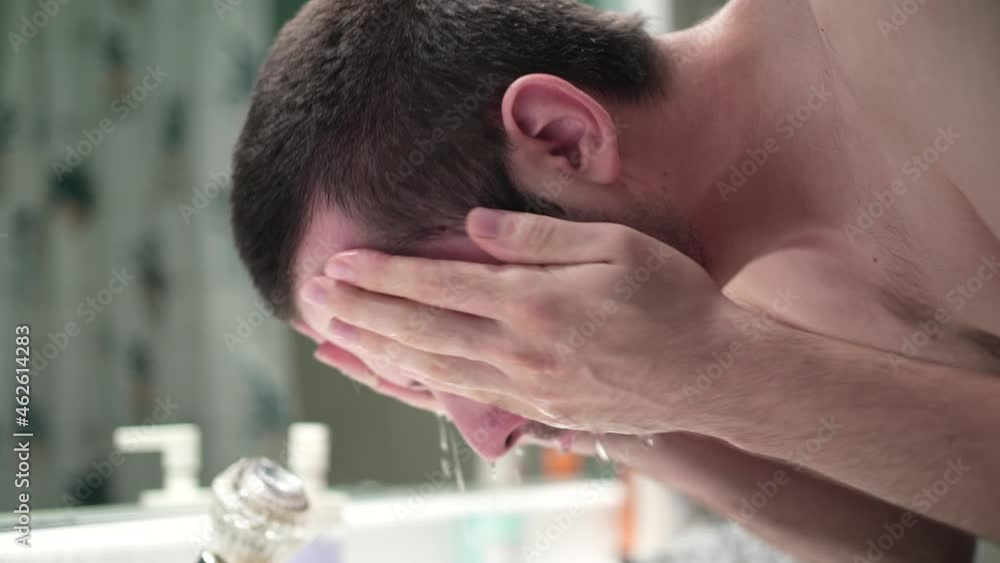 Young Man Washing His Face In the Bathroom Sink in the Morning Young Man Washing His Face In the Bathroom Sink in the Morning