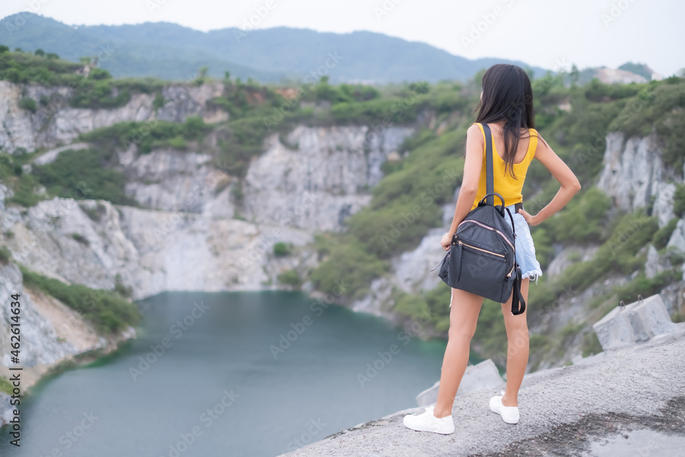 Alone woman standing on blur view landscape  Mountain and River at Grand Canyon Chonburi Thailand. tourism travel summer holiday in nature, being alone, decisiveness, strong and broken heart concept.