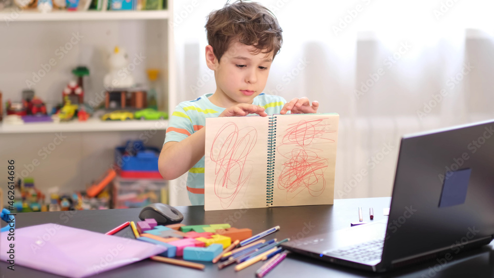 Learn on your schedule. Distance learning online education. A schoolboy boy studies at home and does school homework. A home distance learning. Learn on your schedule. Distance learning online education. A schoolboy boy studies at home and does school homework. A home distance learning.