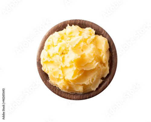 Ghee or clarified butter in wooden bowl, cooking oil, pure ghee isolated on white background. Clarified butter with copy space for text on white. Top view.