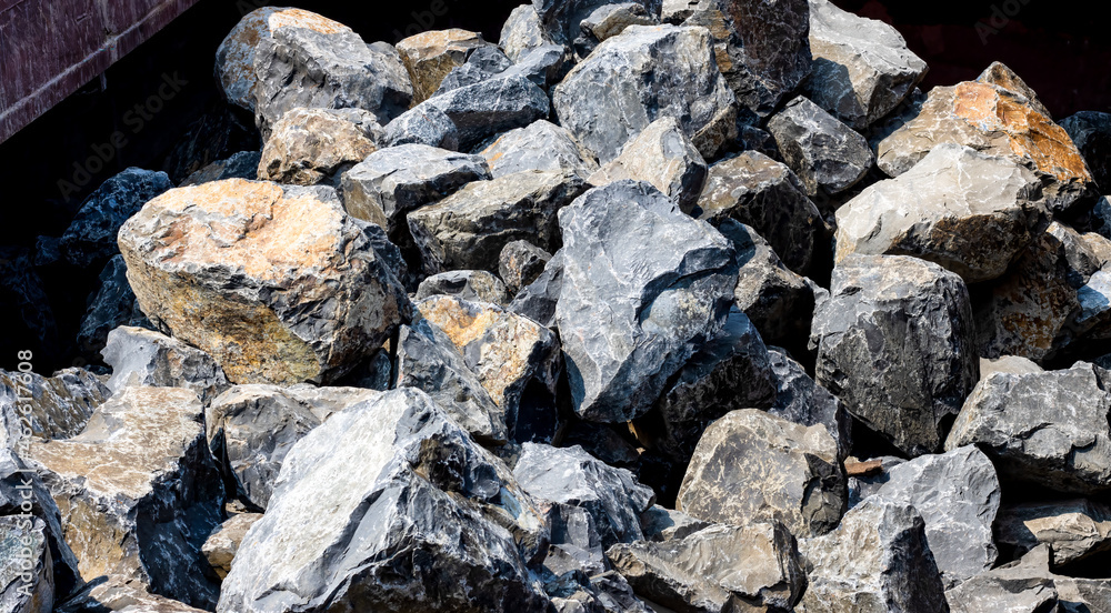 Close up view of a large stones heap on a big container
