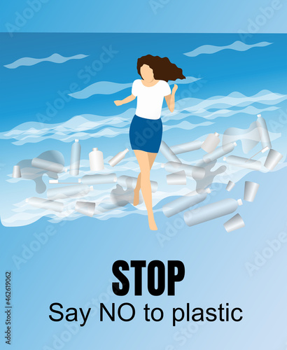 A young girl plays with the waves among the garbage: plastic bags, cups and bottles. Concept zero waste and rejection of plastic.