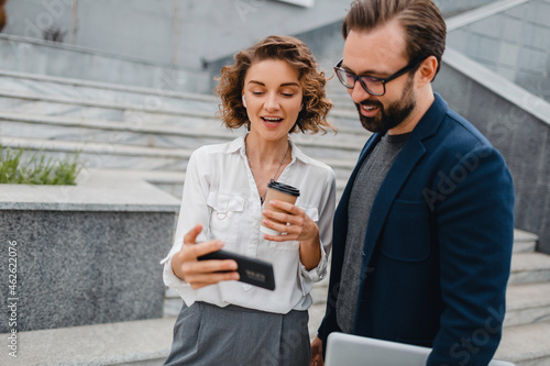 man and woman business partners working together