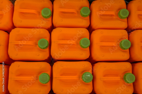 Photo of orange plastic tanks with a green lid