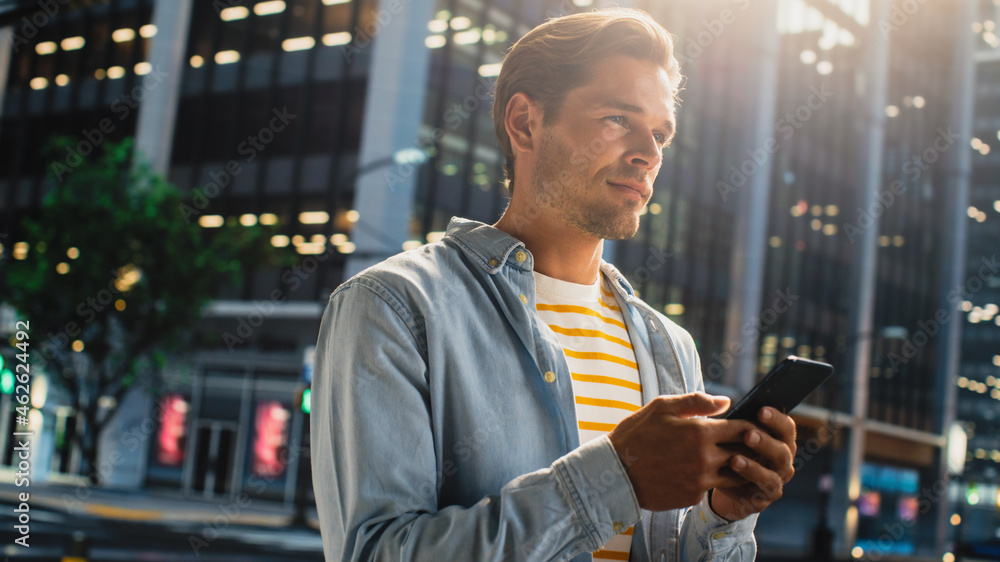 Portrait of a Handsome Young Man Wearing Casual Clothes and Using  Smartphone on the Urban Street in the Evening. Manager in Big City  Connecting with People Online, Messaging and Browsing Internet. Photos