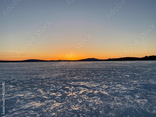 Sunset over ice lake