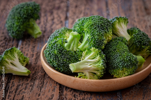 Fresh green broccoli on wooden plate