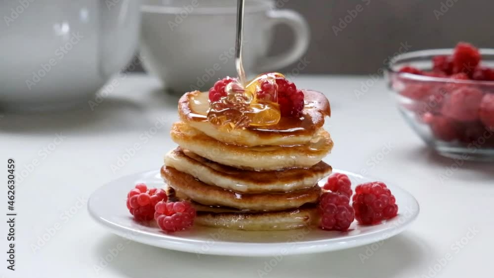 Hot pancakes with raspberries and honey. Hot pancakes with raspberries and honey.