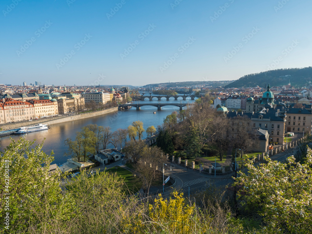 Fototapeta premium Scenic aerial view of Prague Old Town architecture and Charles Bridge over Vltava river seen from Letna hill park, spring sunny day, blue sky, Czech Republic